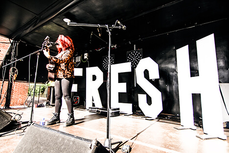 A band playing on stage at a festival